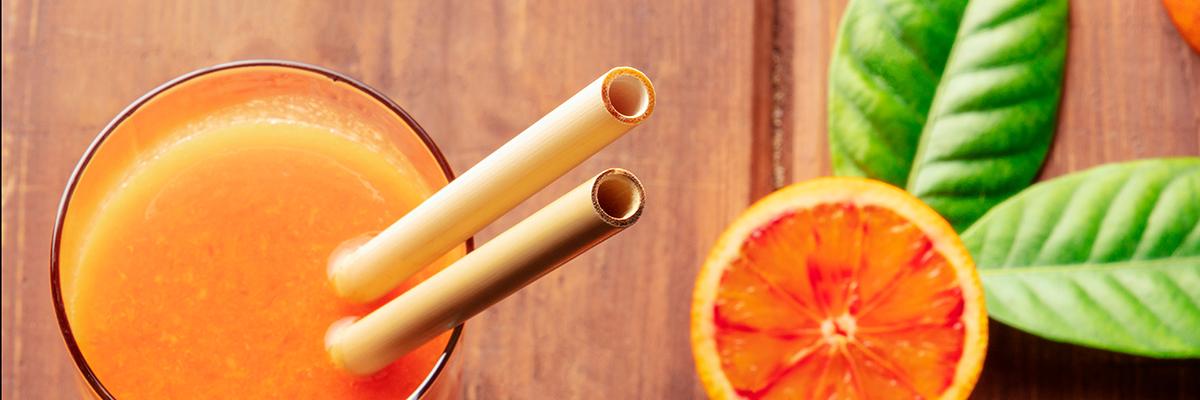Bamboo drinking straws on wooden surface for B2B wholesale