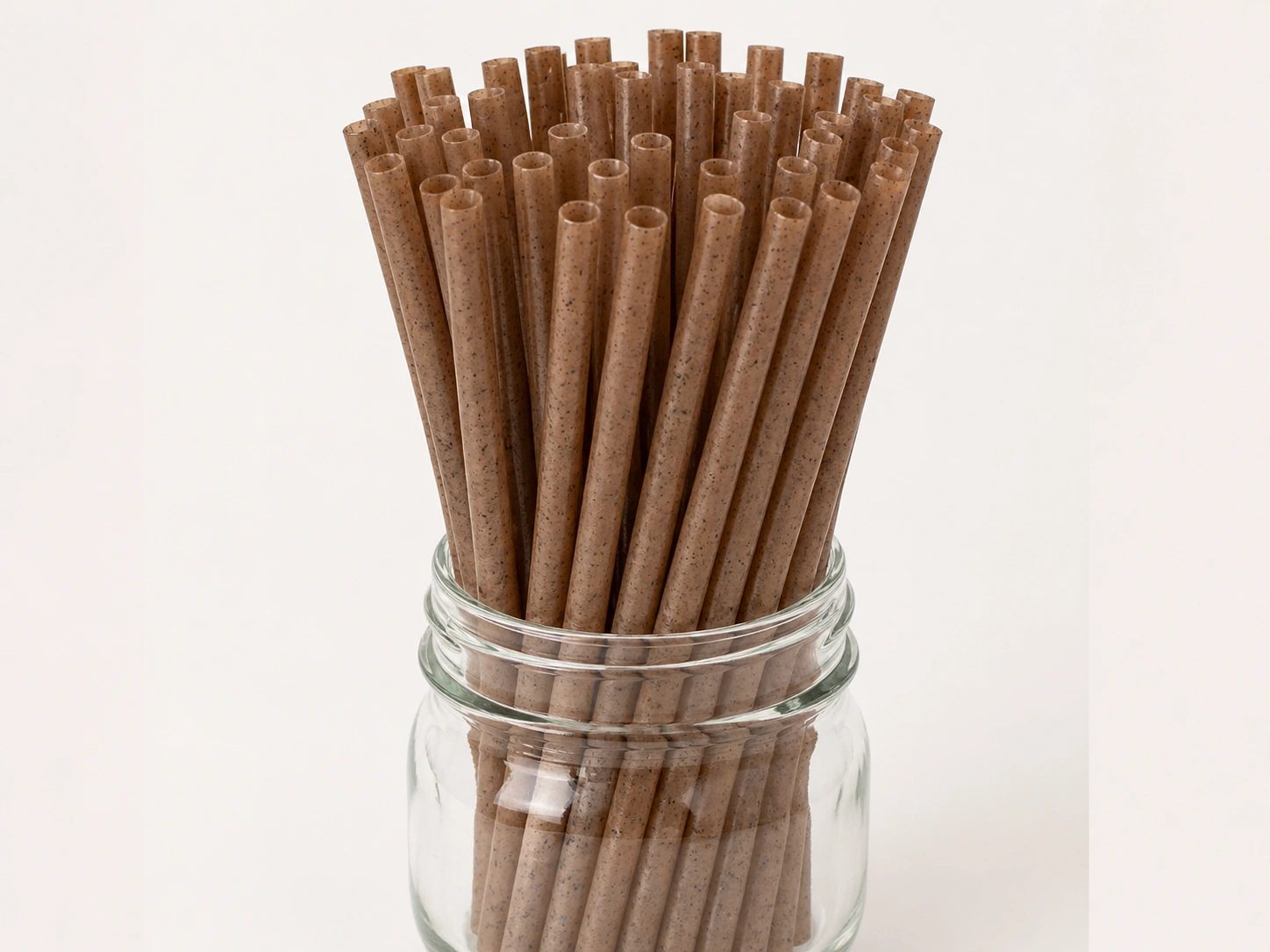 Coffee ground straws displayed in glass jar for wholesale supply